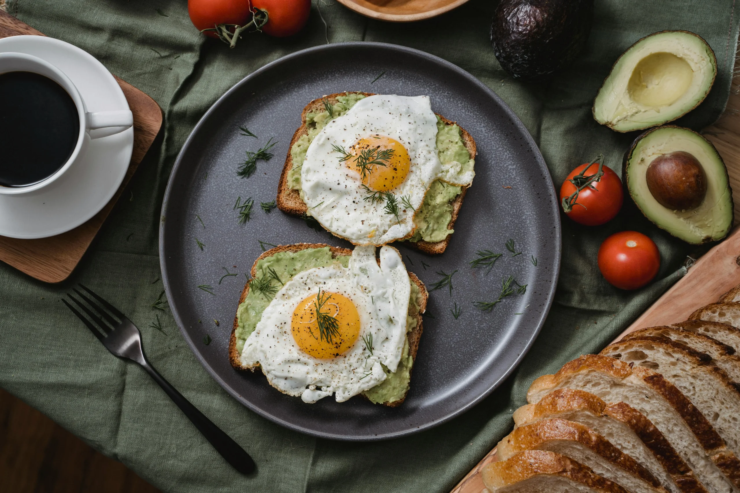 Avocado & Egg Breakfast Toast topped with fresh herbs