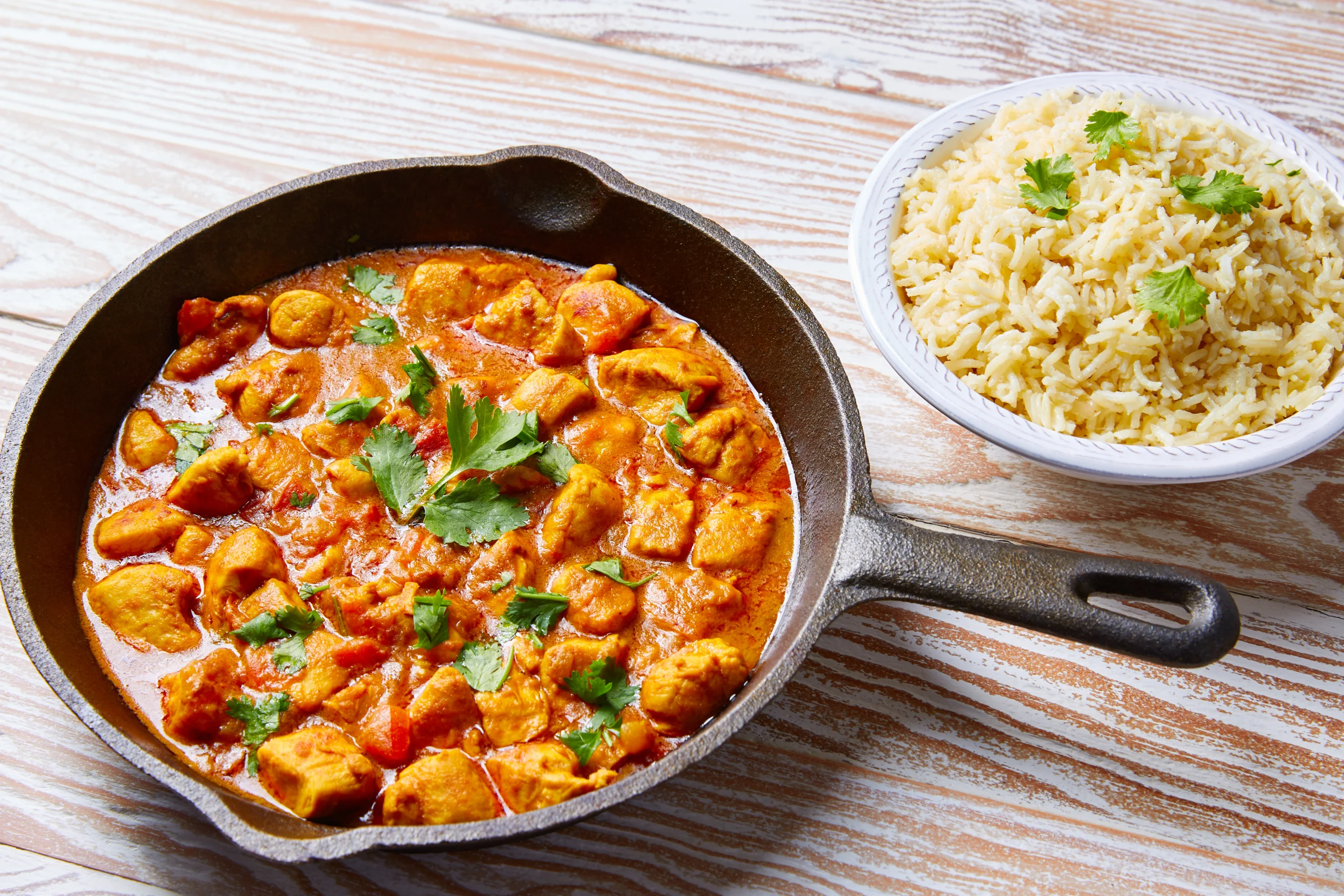 Instant Pot Chicken Curry served with rice and naan, featuring tender chicken, vegetables, and spices in a creamy coconut milk sauce.