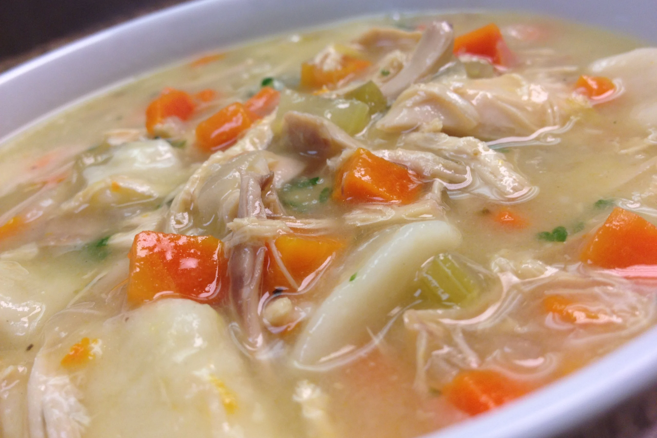 Delicious slow cooker chicken and dumplings with fluffy dumplings and vegetables in a savory broth.