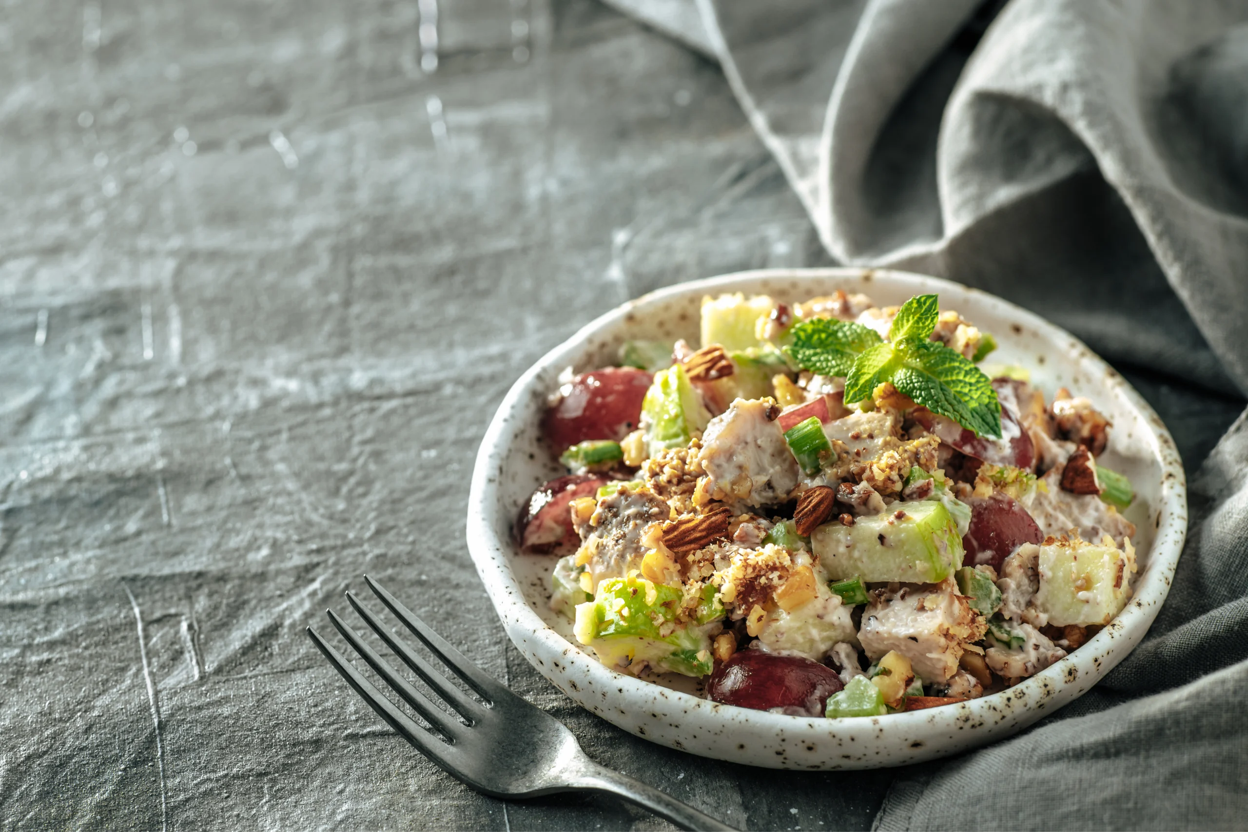 Waldorf salad with apples, celery, and walnuts in a creamy dressing.